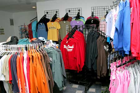 Branded Apparel Display at Welcome Colorful clothing racks at Welcome with branded hoodies, sweatshirts, and t-shirts neatly displayed in a retail space.